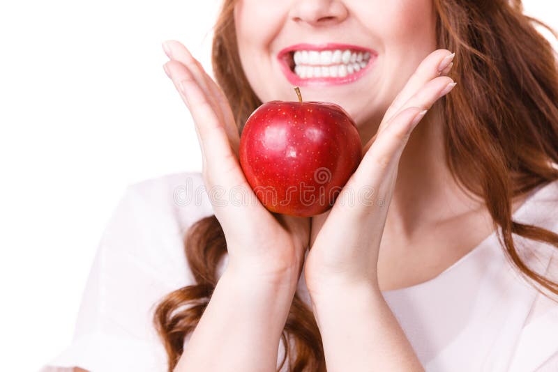 Woman holds apple fruit close to face, isolated royalty free stock photo Woman holds apple fruit close to face, isolated royalty free stock photo