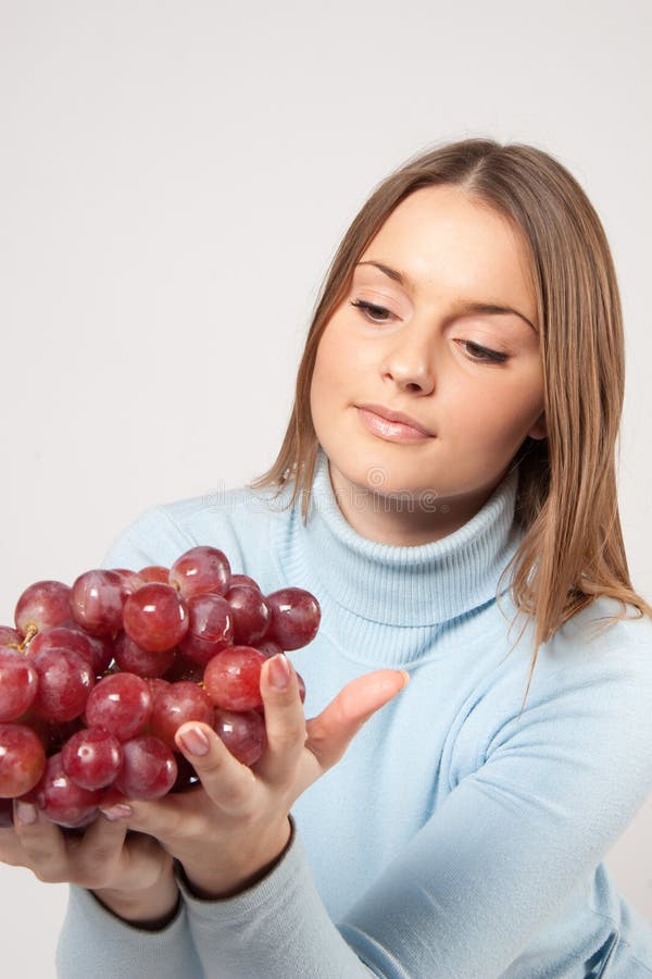 Woman holding red grapes