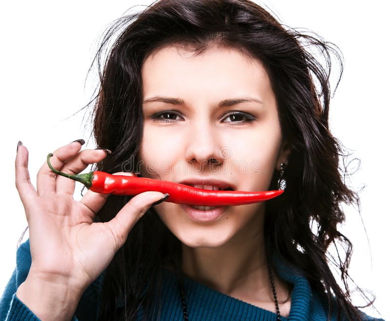 Woman holding red hot chili pepper in mouth