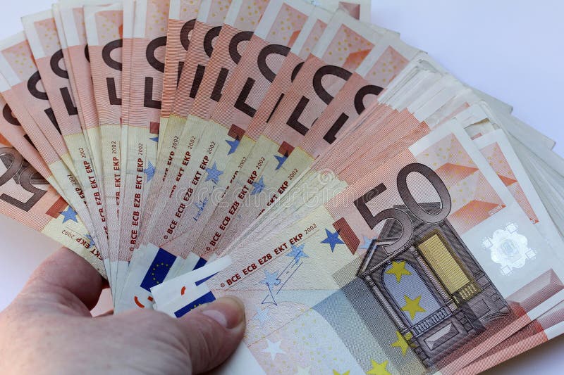 A woman is holding several five-euro notes in her hand