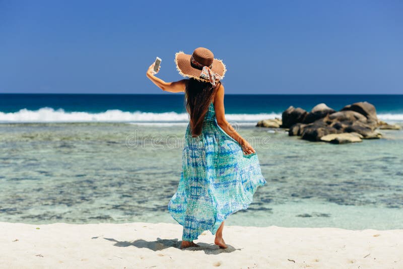 Woman Holding Smartphone on Beach Stock Image - Image of looking ...