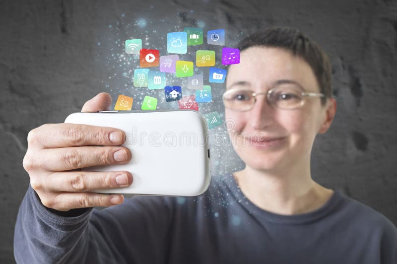 Woman holding a smartphone with modern colorful floating apps and icons. Selective focus.
