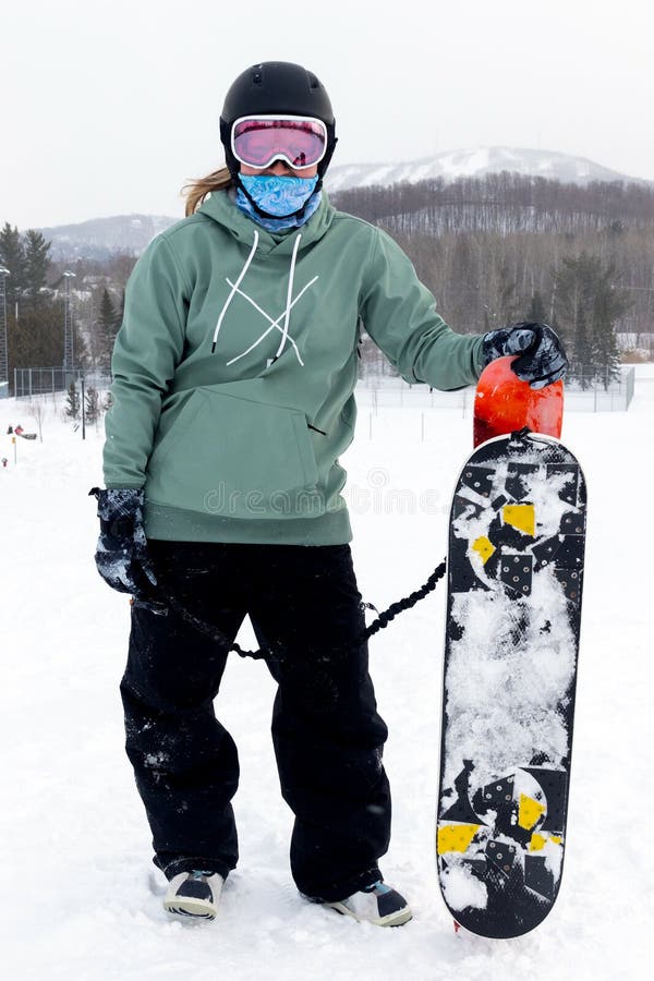 Woman holding a snowdeck snowskate snowboard