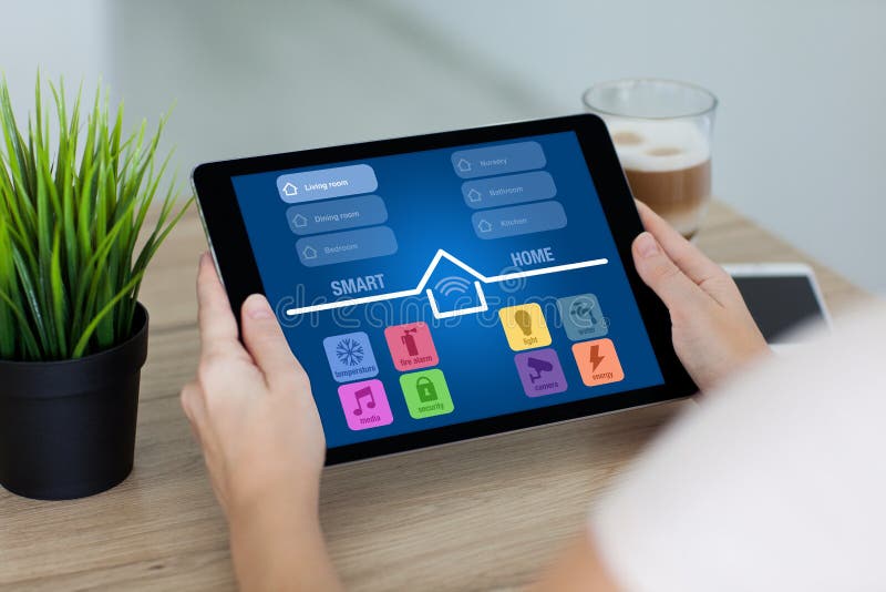 Woman Holding Tablet with App Smart Home Screen in Room Stock Image