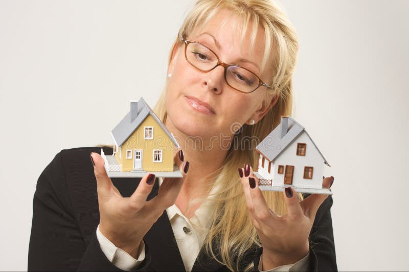 Woman Holding Two Houses