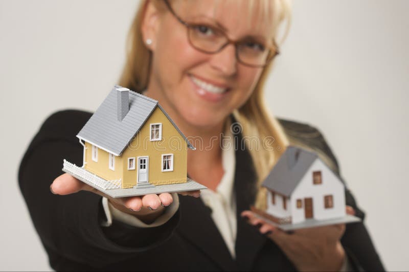 Woman Holding Two Houses