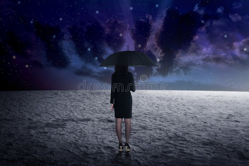 Woman holding umbrella from outer space