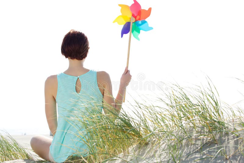 Woman holding wind pinwheel stock photo Woman holding wind pinwheel stock photo