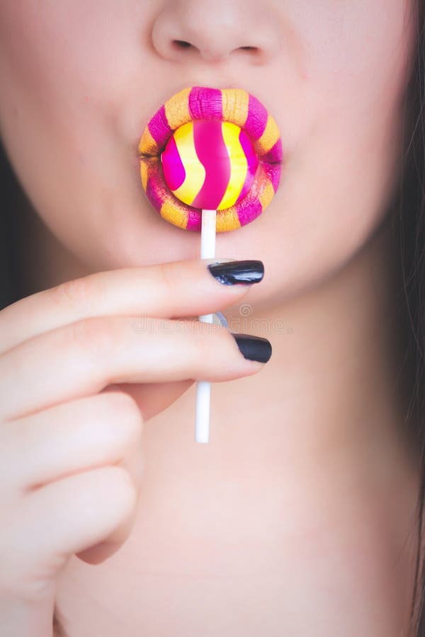 Woman Holding Yellow And Pink Candy Picture. Image: 111823732