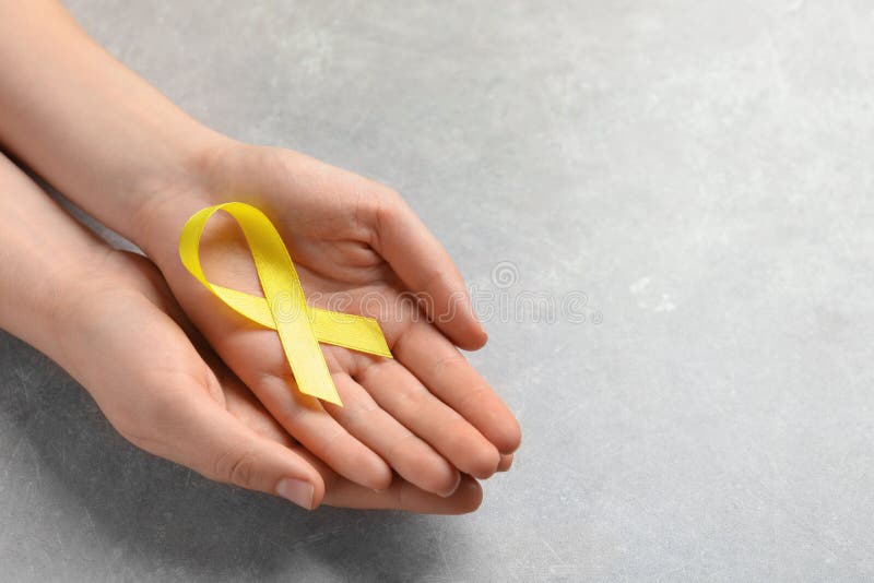 Yellow Ribbon On Light Background. Cancer Concept Stock Photo, Picture and  Royalty Free Image. Image 116011692.