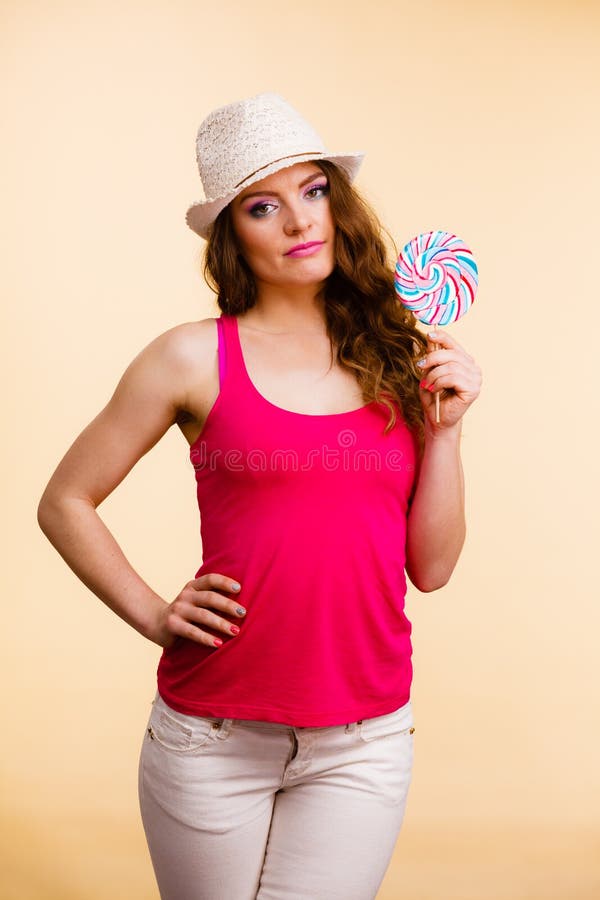Woman holds colorful lollipop candy in hand stock photo Woman holds colorful lollipop candy in hand stock photo
