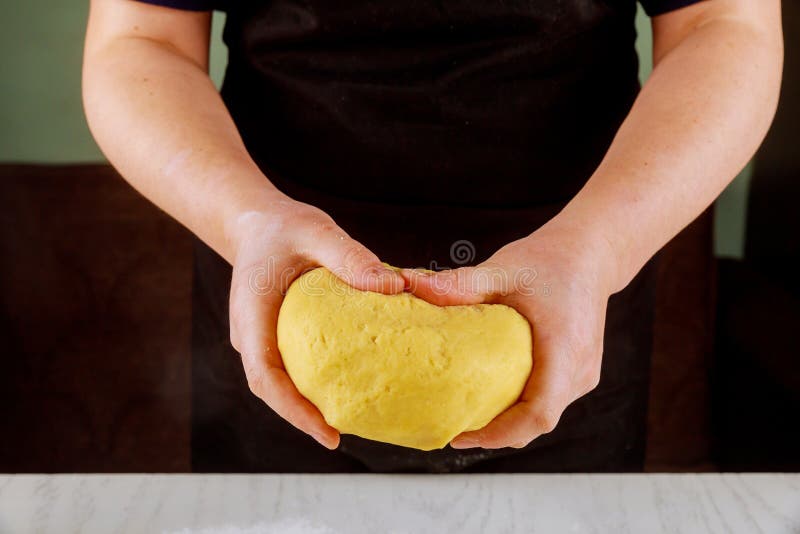 A woman holds dough for making cookies