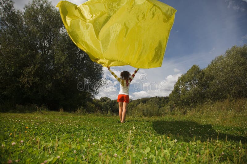 Woman holds in hand developing on wind fabric