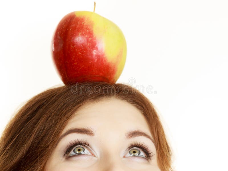 Woman holds on head apple fruit looking up royalty free stock photo Woman holds on head apple fruit looking up royalty free stock photo