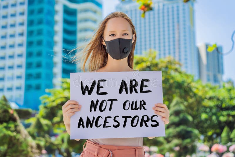 Woman holds a poster with an inscription - we are not our ancestors.