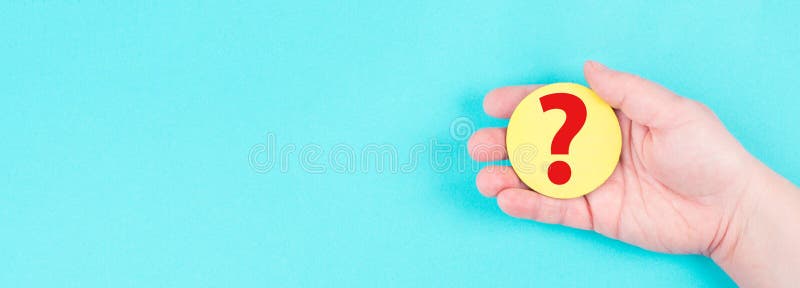Woman holds a red question mark in her hand, blue background, copy space for text royalty free stock photos
