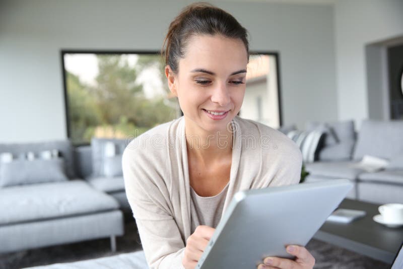 Woman at home websurfing on tablet