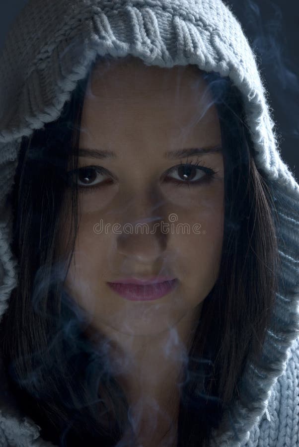 Woman with hood in smoke stock image