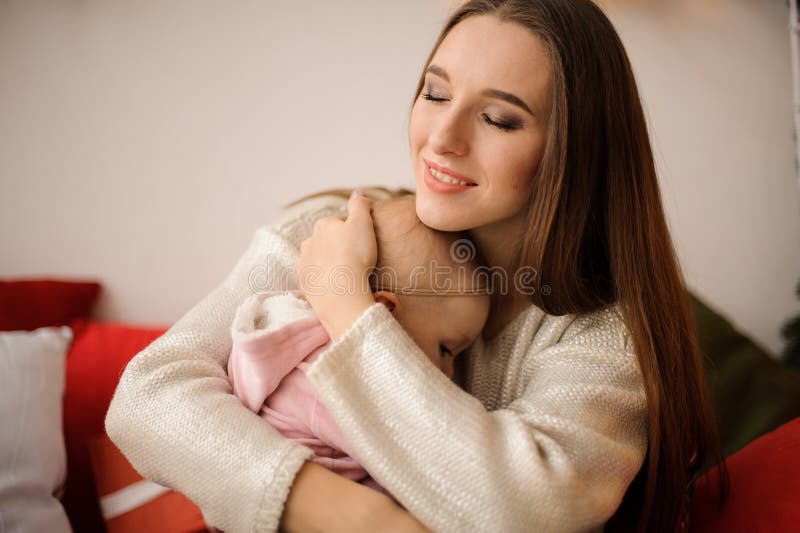 Woman hugging her cute little daughter on hands royalty free stock photography Woman hugging her cute little daughter on hands royalty free stock photography