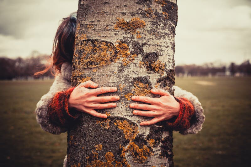 Woman hugging a tree