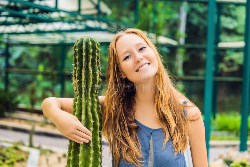 A woman hugs a cactus as her best friend. Problems of friendship royalty free stock images A woman hugs a cactus as her best friend. Problems of friendship royalty free stock images
