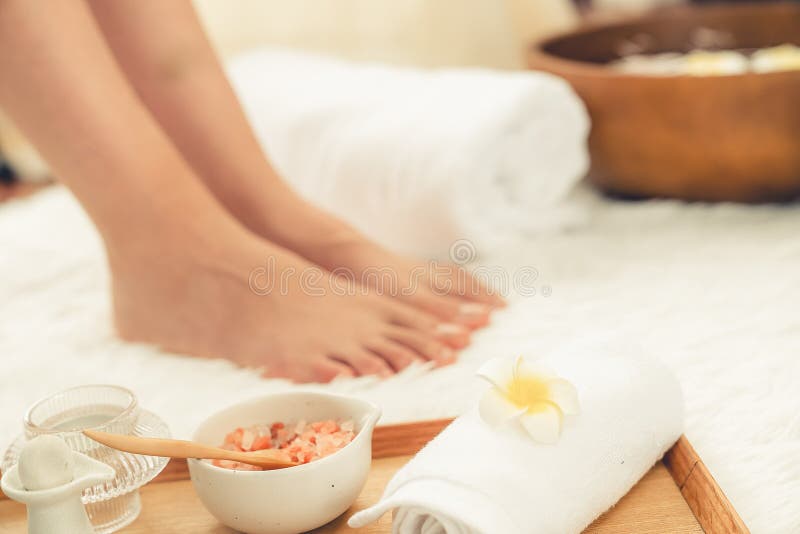 Woman indulges in blissful foot massage at luxurious spa salon. Quiescent