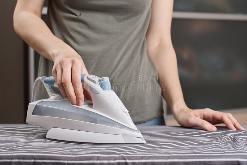 Close Woman's Hand Ironing Cloth Ironing Board Stock Photo by