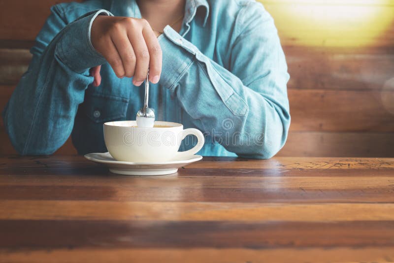 Woman in jeans with hot coffee cup