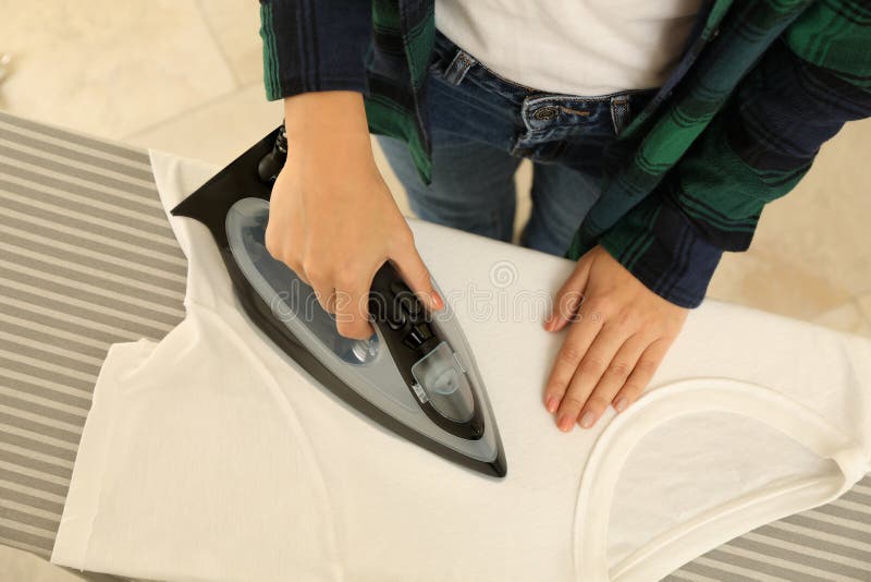 Woman in Jeans Ironing Tshirt with Iron Stock Image Image of laundry