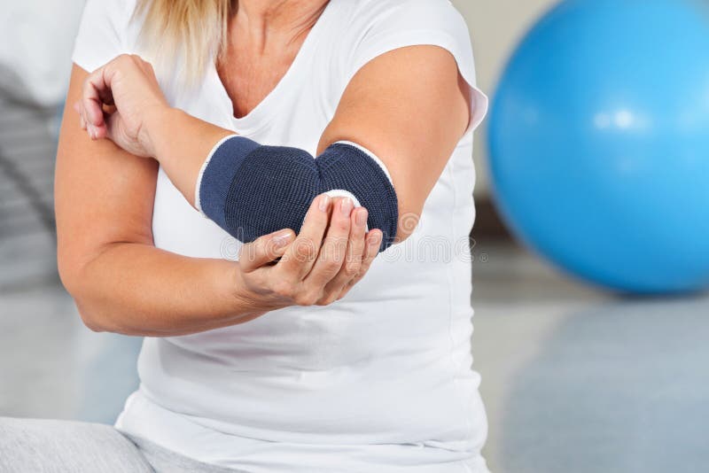 Woman with joint pain and bandage in gym. Woman with joint pain and bandage in gym
