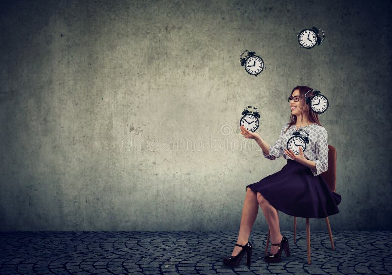 Woman juggling with alarm clocks.