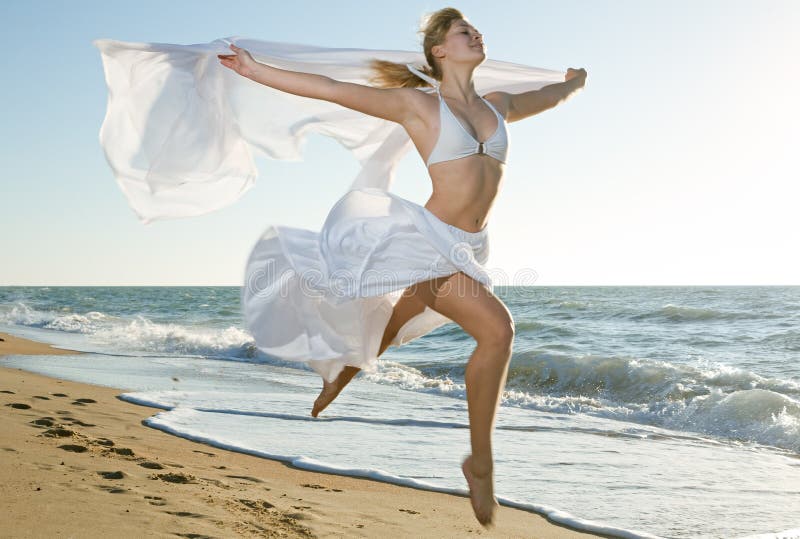 Woman jumping on the beach