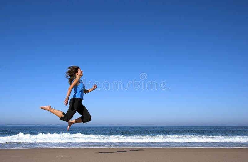 Woman jumping in the beach