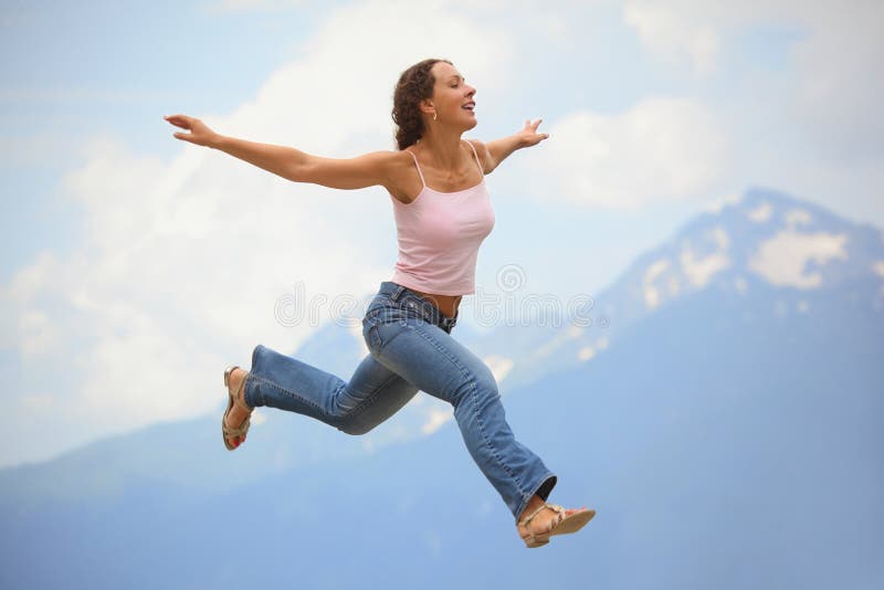 Woman is Jumping with Hands Wide Apart Stock Photo Image of person