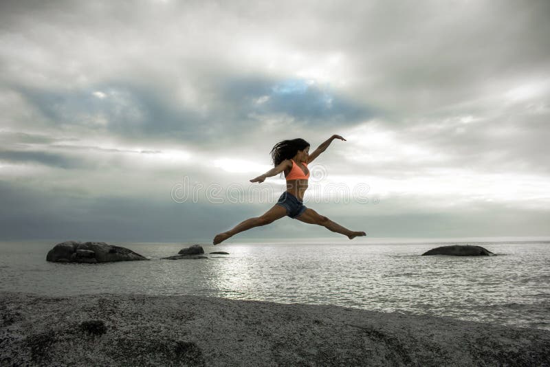 Woman Jumping On A Rock At Sunset On Bakovern Beach Cape Town Stock Photo Image Of Marine