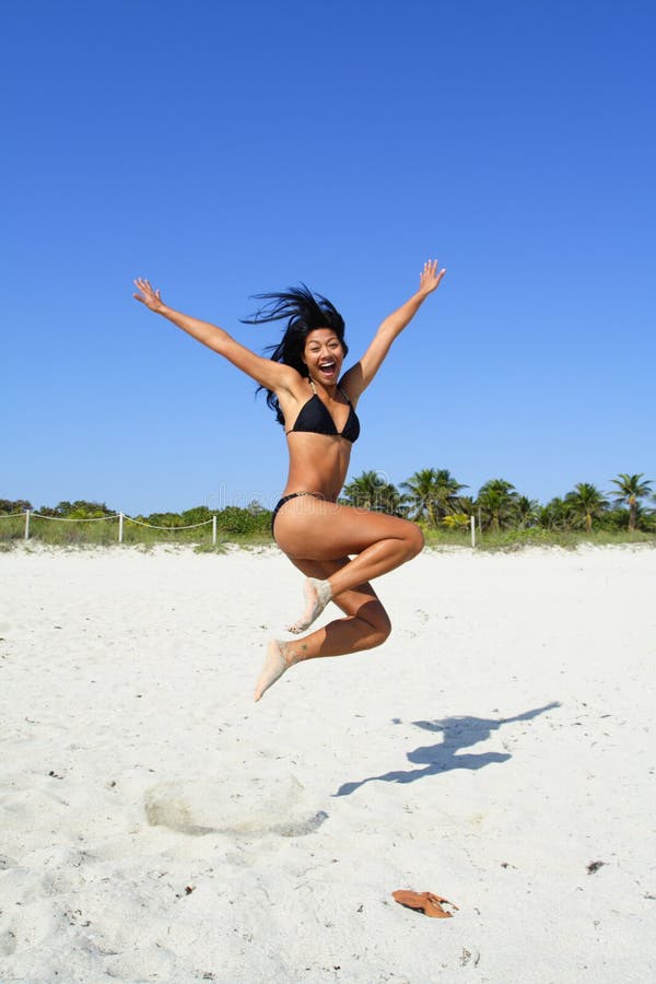 Woman Jumping on the Sand