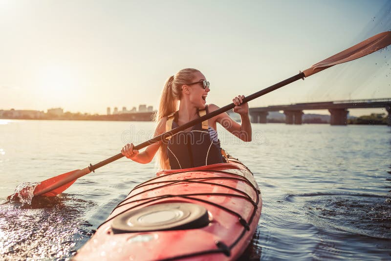 Woman kayaking on sunset stock photo. Image of exploring 97893142