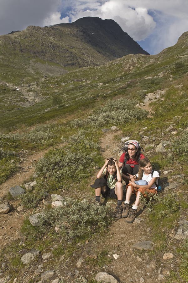 Woman with kids hiking in mountains, Norway