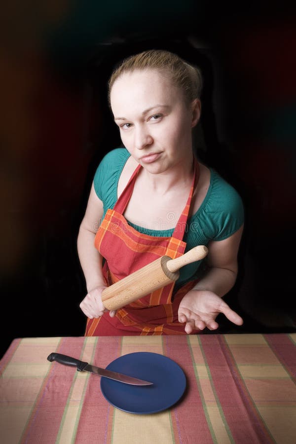 Woman with kitchen tool (rolling pin)