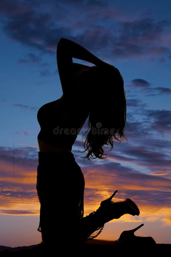 Woman on knees head back silhouette