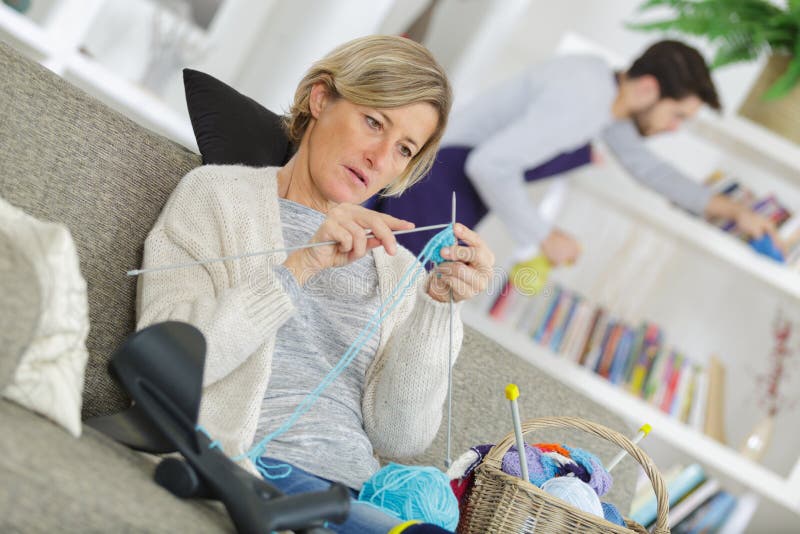 Woman Knitting while Man Cleaning Stock Image - Image of chores ...