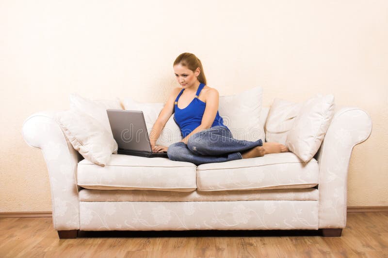 Woman with a laptop on a lounge