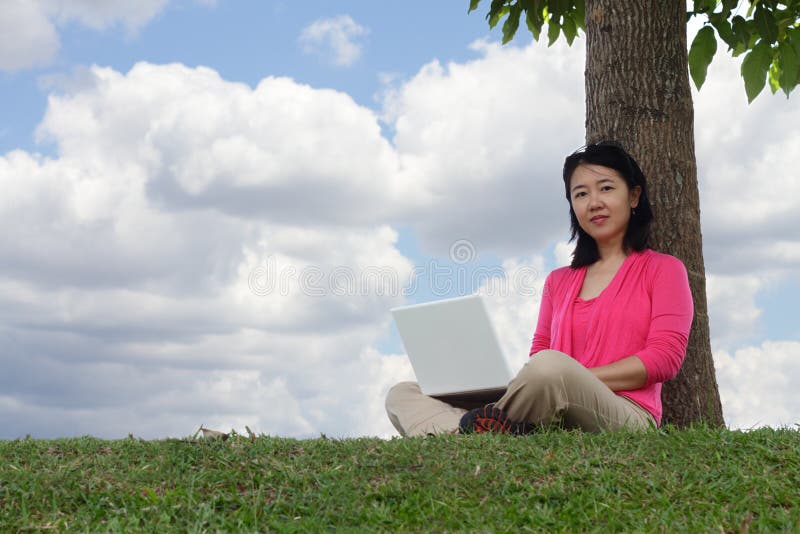 Woman with laptop outdoors