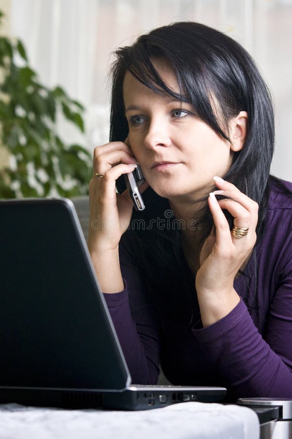 Woman on laptop and phone