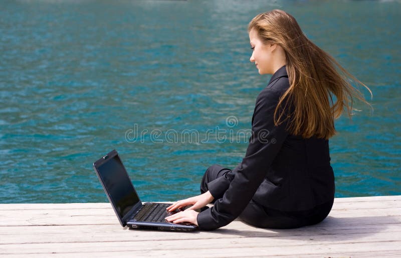 Woman with laptop and sea