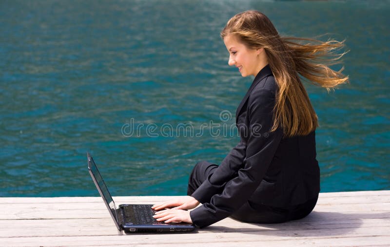 Woman with laptop and sea