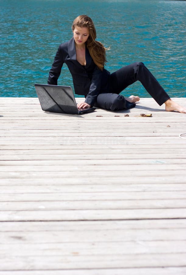 Woman with laptop and sea