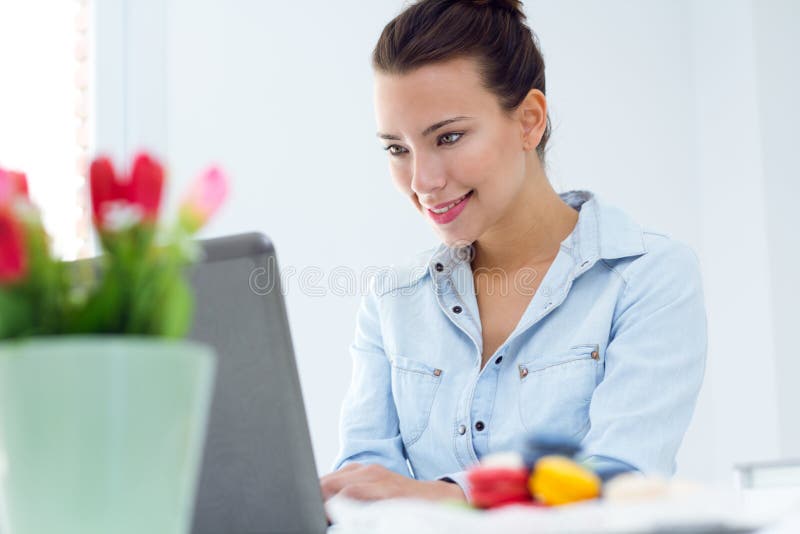 Woman with laptop working at home royalty free stock photo