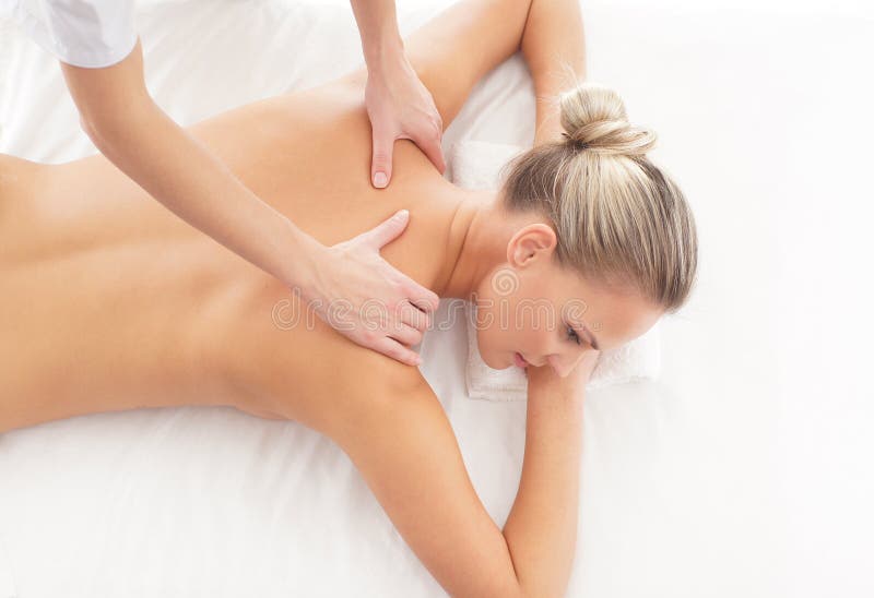 A woman laying on a spa massage procedure