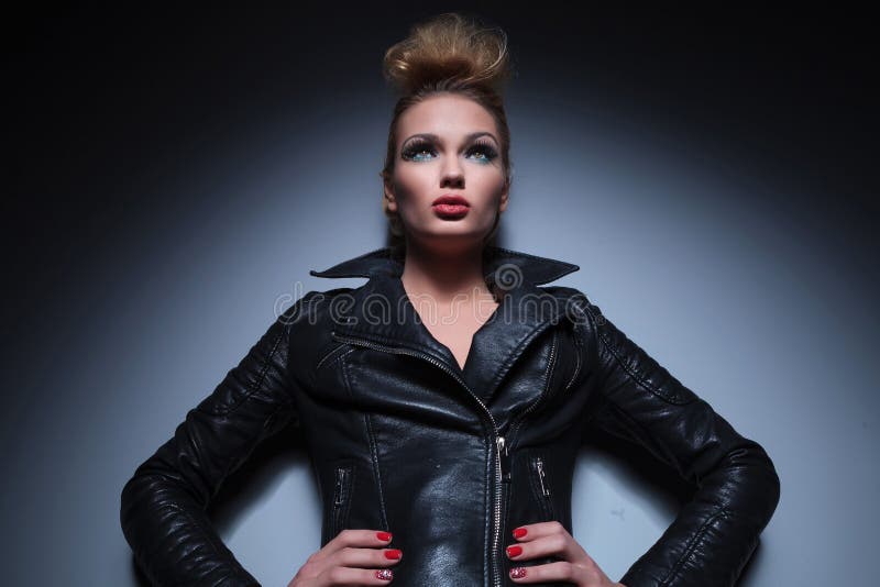 Woman in Leather Jacket Standing with Hands on Hips and Looking Stock ...